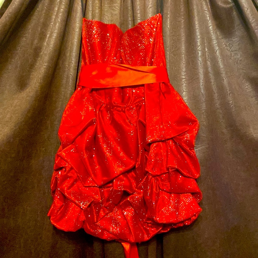 This short red strapless formal has red and silver sequins